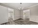 Bright dining area with wood-look flooring, a stylish chandelier, and an easy access to other rooms at 5058 Rock Springs Rd, Lithonia, GA 30038