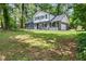 Charming two-story home featuring a gray brick exterior and well-maintained lawn at 5058 Rock Springs Rd, Lithonia, GA 30038