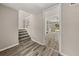 Open foyer with wood-look floors, staircase and view into the home at 5058 Rock Springs Rd, Lithonia, GA 30038