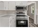 Close-up of a well-equipped kitchen with stainless steel appliances and white cabinets, creating a clean, modern feel at 5058 Rock Springs Rd, Lithonia, GA 30038