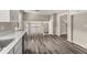 Open-concept kitchen area showcasing wood-look floors, a stainless steel dishwasher, and an inviting view of the home at 5058 Rock Springs Rd, Lithonia, GA 30038