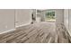 Spacious living area featuring wood-look floors, neutral paint, and sliding glass doors at 5058 Rock Springs Rd, Lithonia, GA 30038