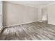 Spacious living room with attractive wood-look floors and neutral walls, bathed in natural light from the window at 5058 Rock Springs Rd, Lithonia, GA 30038
