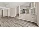 Inviting living room with stylish wood-look floors and staircase access to a bright, modern kitchen at 5058 Rock Springs Rd, Lithonia, GA 30038