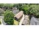 Aerial view highlighting the property nestled among mature trees, with a screened porch and extra storage building at 1363 Sylvan Ne Cir, Brookhaven, GA 30319
