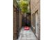Backyard exterior with spiral staircase, ladder, brick walls, and a cornhole game at 1363 Sylvan Ne Cir, Brookhaven, GA 30319