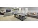 Finished basement features a ping pong table, large sectional couch, and neutral color palette at 1363 Sylvan Ne Cir, Brookhaven, GA 30319