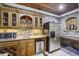 Basement wet bar with brick backsplash, wood cabinets, stainless refrigerator, and tile floors at 1363 Sylvan Ne Cir, Brookhaven, GA 30319