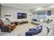 Comfortable basement media room features a large sectional couch, leather chair and big screen tv at 1363 Sylvan Ne Cir, Brookhaven, GA 30319