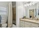 Well-lit bathroom featuring vanity with tile flooring and shower with curtain at 1363 Sylvan Ne Cir, Brookhaven, GA 30319