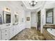 Luxurious bathroom with dual vanities, a soaking tub, marble floors, and a walk-in shower at 1363 Sylvan Ne Cir, Brookhaven, GA 30319