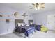 bedroom featuring two twin beds, ceiling fan, and planetary-themed decor at 1363 Sylvan Ne Cir, Brookhaven, GA 30319