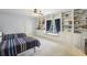 Spacious bedroom showcasing built-in bookshelves, window seating, and carpet flooring at 1363 Sylvan Ne Cir, Brookhaven, GA 30319