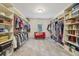 Walk-in closet with custom shelving and storage solutions, perfect for organizing clothes and accessories at 1363 Sylvan Ne Cir, Brookhaven, GA 30319