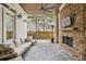 Inviting covered patio with stone fireplace, wood ceiling, outdoor seating, and tv at 1363 Sylvan Ne Cir, Brookhaven, GA 30319