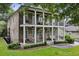 Elegant two-story brick home with double porches and ample seating in a well-maintained front yard at 1363 Sylvan Ne Cir, Brookhaven, GA 30319