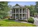 Two-story brick home with dual front porches supported by columns, surrounded by green landscaping at 1363 Sylvan Ne Cir, Brookhaven, GA 30319