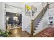 Elegant foyer with staircase, hardwood floors, and a view into the home office at 1363 Sylvan Ne Cir, Brookhaven, GA 30319
