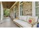 Inviting front porch with comfortable seating and swing, perfect for relaxing and enjoying the outdoors at 1363 Sylvan Ne Cir, Brookhaven, GA 30319