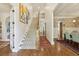 Bright hallway featuring hardwood floors, a staircase, and access to various rooms at 1363 Sylvan Ne Cir, Brookhaven, GA 30319