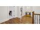 Upstairs hallway offers hardwood floors, wood railing and a bench with decorative pillows at 1363 Sylvan Ne Cir, Brookhaven, GA 30319