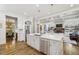 Spacious kitchen with white cabinets, a large island, and open concept to the living area at 1363 Sylvan Ne Cir, Brookhaven, GA 30319