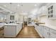 Modern kitchen with white cabinets, stainless steel appliances, and a view to the dining and living areas at 1363 Sylvan Ne Cir, Brookhaven, GA 30319