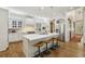 Modern white kitchen featuring a large center island, stainless steel appliances, and hardwood flooring at 1363 Sylvan Ne Cir, Brookhaven, GA 30319