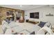 Spacious living room featuring a sectional couch, large TV, and brick archway to kitchen at 1363 Sylvan Ne Cir, Brookhaven, GA 30319