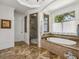 Elegant bathroom showcasing a soaking tub, tiled shower, and large window with natural light at 1363 Sylvan Ne Cir, Brookhaven, GA 30319