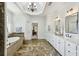 Luxurious primary bathroom featuring dual vanities, tile floors, a soaking tub, and a separate shower at 1363 Sylvan Ne Cir, Brookhaven, GA 30319