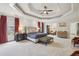 Spacious primary bedroom with a tray ceiling, carpet floors, multiple windows, and sitting area at 1363 Sylvan Ne Cir, Brookhaven, GA 30319