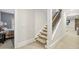 Carpeted staircase with wooden handrail leading to an upper level at 1363 Sylvan Ne Cir, Brookhaven, GA 30319