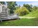 Backyard view of a deck with stairs, a lawn, and lush greenery at 4292 Hurt Bridge Rd, Cumming, GA 30028