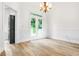 Open dining room with hardwood floors, wainscoting, and french doors leading to the porch at 4292 Hurt Bridge Rd, Cumming, GA 30028