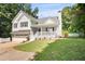 Charming home with an attached garage, inviting front porch, and well-manicured lawn at 4292 Hurt Bridge Rd, Cumming, GA 30028