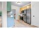 Bright kitchen with stainless steel appliances, light wood floors, and white cabinets at 4292 Hurt Bridge Rd, Cumming, GA 30028