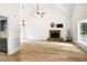 Spacious living room with hardwood floors, stone fireplace, and large windows at 4292 Hurt Bridge Rd, Cumming, GA 30028