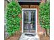 Charming brick building entrance framed by manicured greenery at 55 Delmont Ne Dr # C3, Atlanta, GA 30305