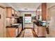 Galley kitchen featuring wooden cabinets, granite countertops, and stainless steel appliances at 55 Delmont Ne Dr # C3, Atlanta, GA 30305