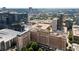 Striking aerial view of a luxury high-rise in a thriving city, surrounded by lush greenery and other high-rise buildings at 30 5Th Ne St # 1010, Atlanta, GA 30308