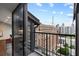 Balcony featuring views of the city skyline and a glimpse of the modern kitchen interior at 30 5Th Ne St # 1010, Atlanta, GA 30308