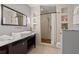 Modern bathroom featuring a floating sink, shower with a wooden floor, and built-in shelves at 30 5Th Ne St # 1010, Atlanta, GA 30308