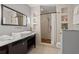 Well-lit bathroom with a contemporary sink, a spacious shower and recessed storage shelves at 30 5Th Ne St # 1010, Atlanta, GA 30308