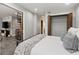 Bedroom with queen-size bed, connecting living room with spiral staircase, and closet at 30 5Th Ne St # 1010, Atlanta, GA 30308