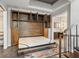 Murphy bed featuring wooden cabinets, rug, and natural light from the connecting bathroom and hallway at 30 5Th Ne St # 1010, Atlanta, GA 30308