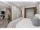 Bright and airy bedroom showcasing modern gray walls and easy access to the living room via the spiral stairs at 30 5Th Ne St # 1010, Atlanta, GA 30308