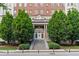 Beautiful building entrance featuring a grand staircase, mature trees, and classic architectural elements at 30 5Th Ne St # 1010, Atlanta, GA 30308