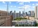 Sweeping daytime cityscape featuring modern buildings, lush greenery, and clear skies at 30 5Th Ne St # 1010, Atlanta, GA 30308