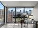 Breathtaking cityscape view from the living room window, complete with a modern desk setup at 30 5Th Ne St # 1010, Atlanta, GA 30308
